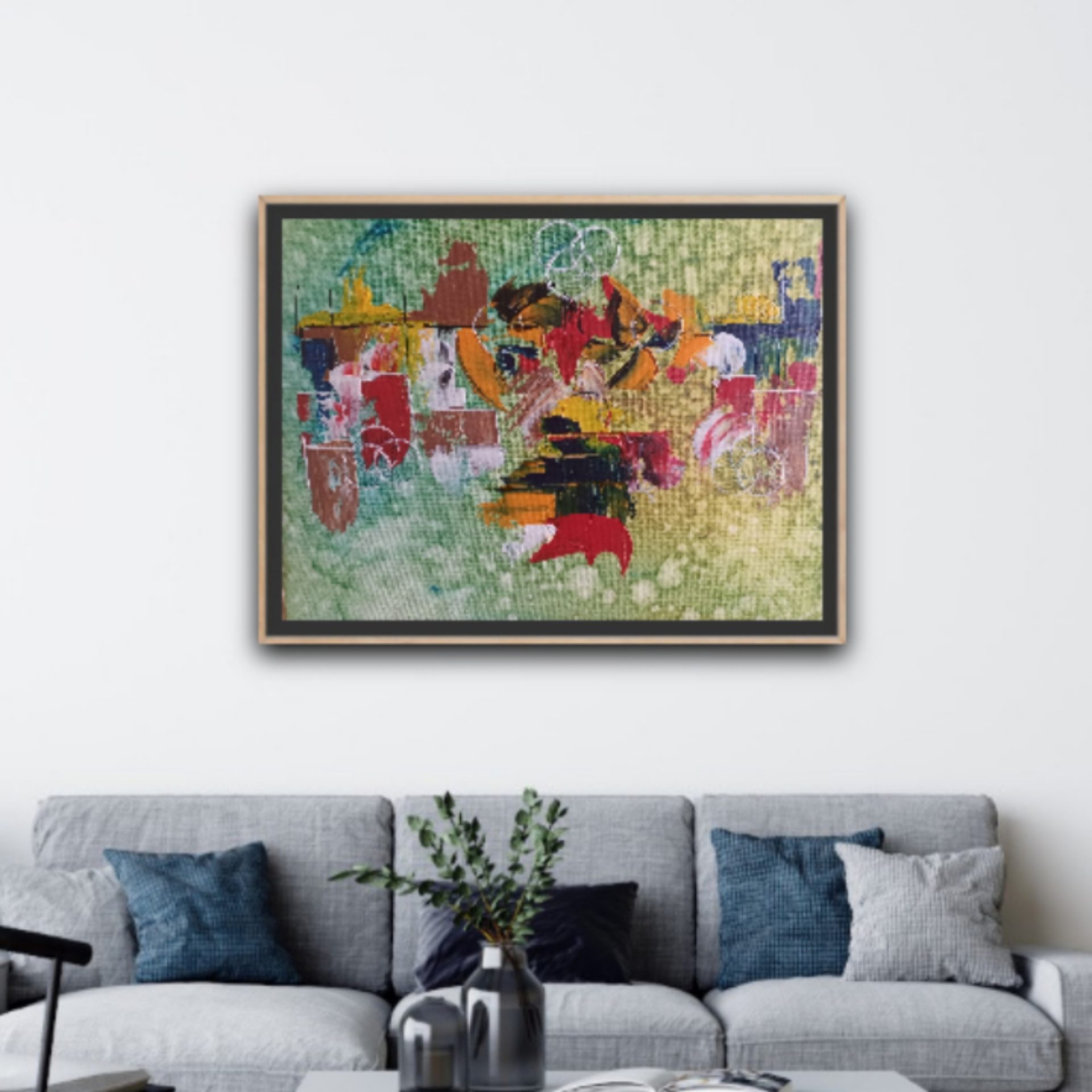 Colorful abstract painting hanging above couch