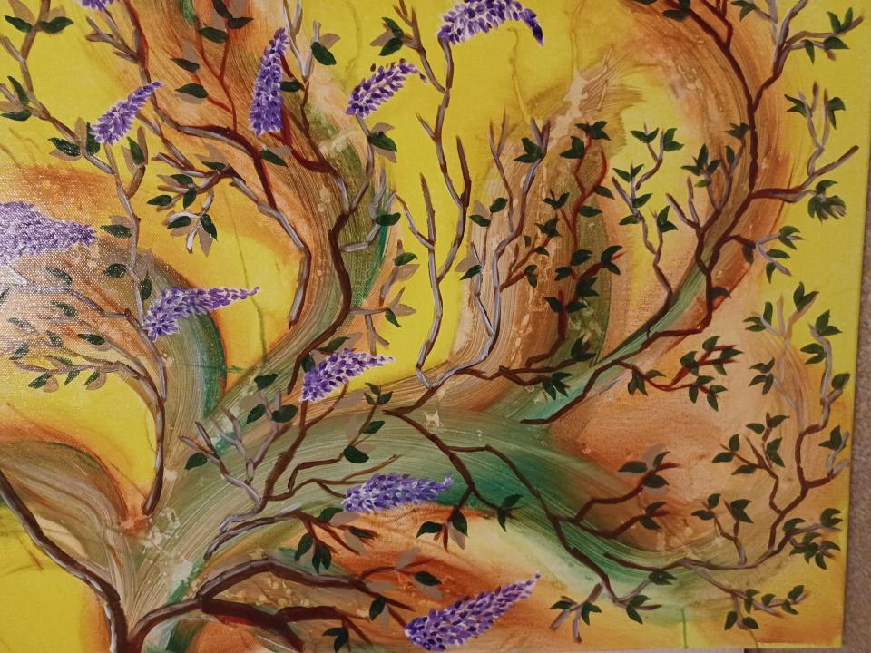 Branches with purple flowers on yellow